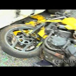 Bike crashes into parked automobile