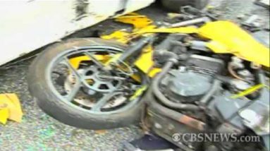 Bike crashes into parked automobile