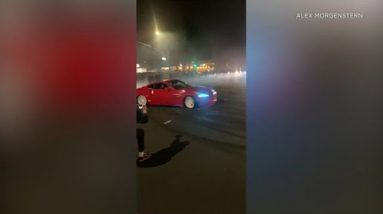 Street racers develop donuts in some unspecified time in the future of illegal intersection takeover in Laguna Niguel I ABC7