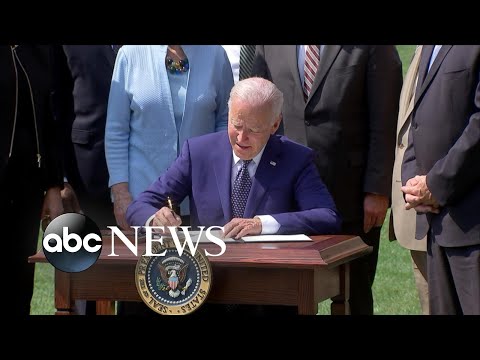 Biden signs electrical automobile executive repeat, praises autoworkers