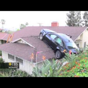 Airborne automobile ends up on storage roof