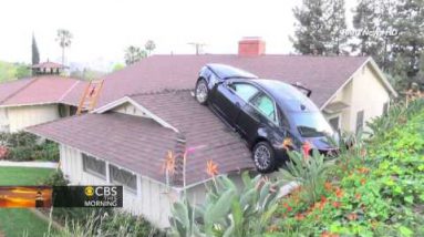 Airborne automobile ends up on storage roof