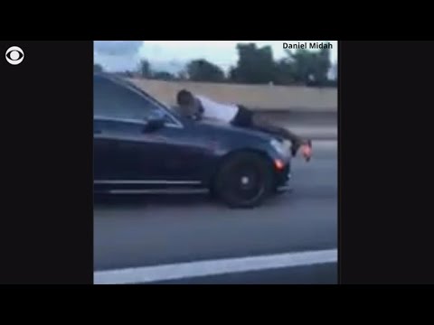 Man calls 911 whereas clinging to speeding automobile