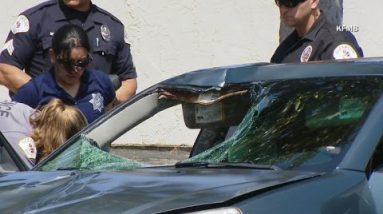 Suspect drives off with victim caught in car windshield