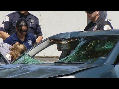 Suspect drives off with victim caught in car windshield
