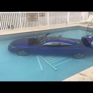 Vehicle rolls into pool with father and daughter inner