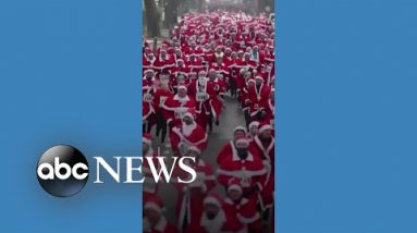 A total bunch of Santas trip in German metropolis for annual fun trip