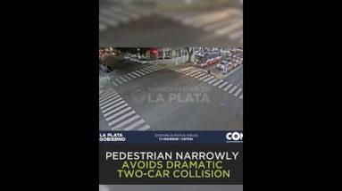 Pedestrian crossing street narrowly misses 2 colliding vehicles that fling past him at excessive-speeds